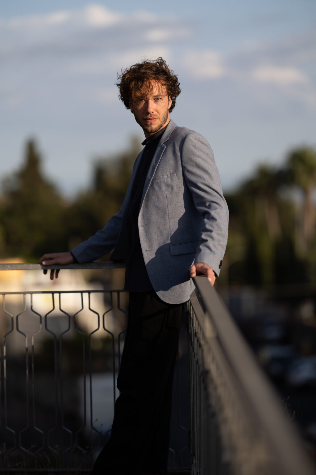 Joseph Sieber leaning on a railing in evening light